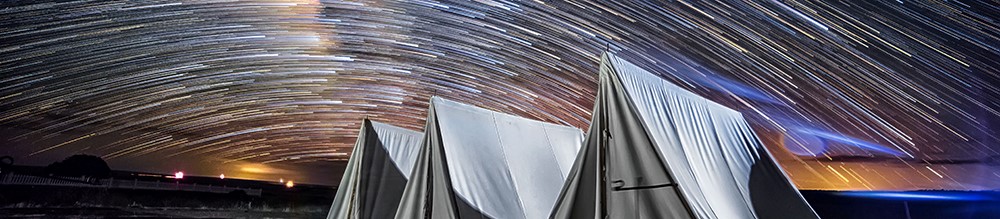 starry night white army tents with starts in background