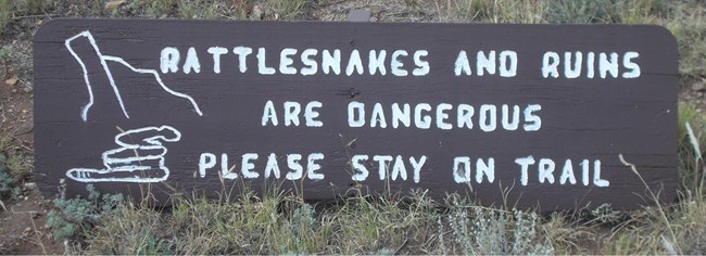 Rattlesnake and Adobe Remnants caution sign