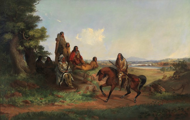 Painting of an American Indian man on horseback in front of a family of American Indians beside a tree with a grassy field in the background.