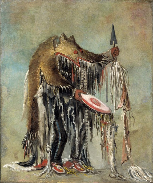Painting of American Indian man wearing a bearskin cape with long tassels holding a spear and round red disk with tassels.