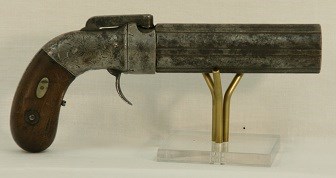 A gun with a wooden handle and thick metal barrel.
