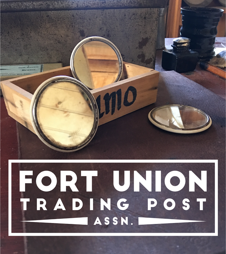 Wood box with three round mirrors and white text stating Fort Union Trading Post Association