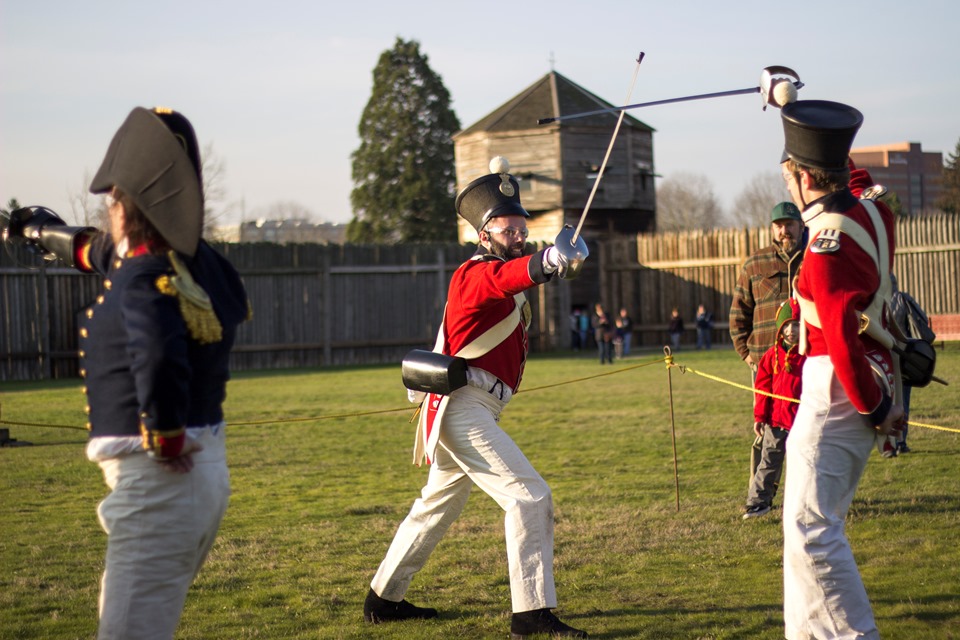 Saber Demonstration Photo of two reenactors in historic military costume inside the fort demonstrating saber techniques.
