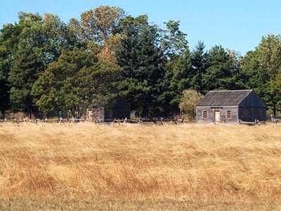 Photo of small cabins in a field. Photo of small cabins in a field.