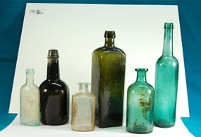 Six bottles of various sizes and colors from the excavation of the Sutler Store privy.