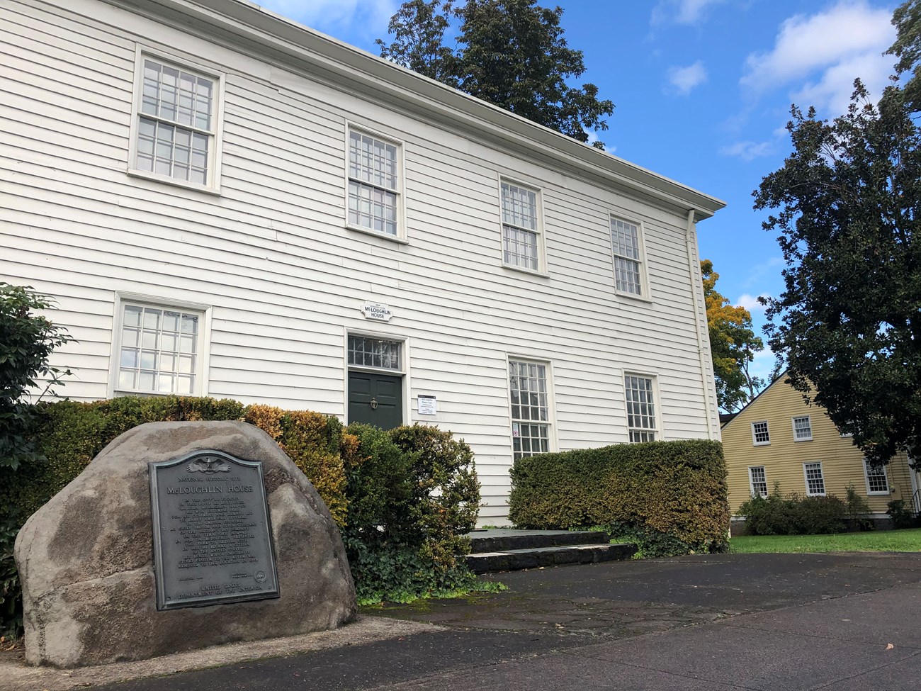 Photo of large, white square building taken from the southeast corner.