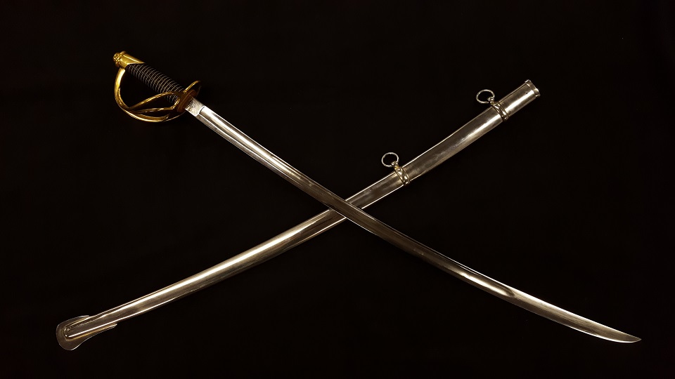 Model 1840 Cavalry Saber "Old Wrist-Breaker" with metal scabbard. This sword is 44 inches long with a 35 inch blade and weighs approximately 2.5 pounds.