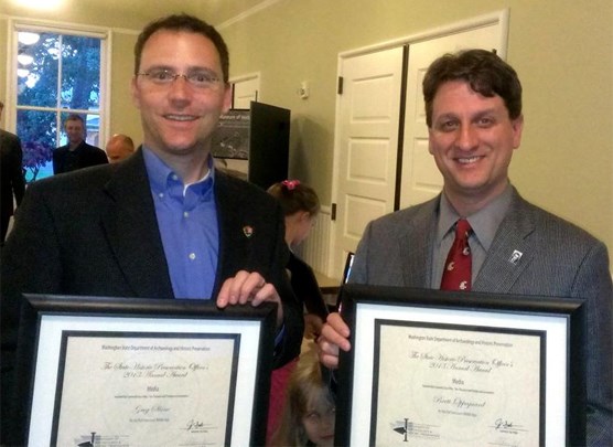 Image of Greg Shine and Brett Oppegaard holding framed award certificates.