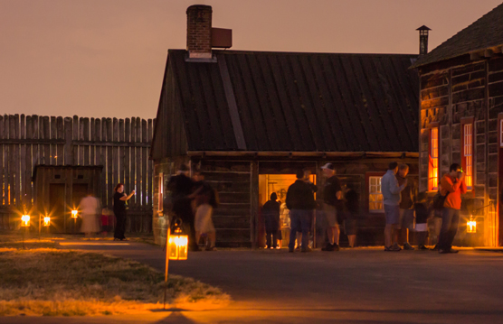 Image of visitors enjoying the campfires & candlelight special event by lantern light in 2012.