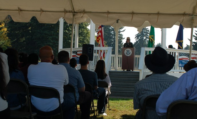 Crowd's-eye view of Superintendent Fortmann addressing the 2012 Citizenship Ceremony from the Bandstand on the historic Parade Ground.