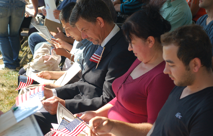 Candidates for citizenship sitting and listening to the keynote speaker at the 2012 Citizenship Ceremony at Fort Vancouver NHS.