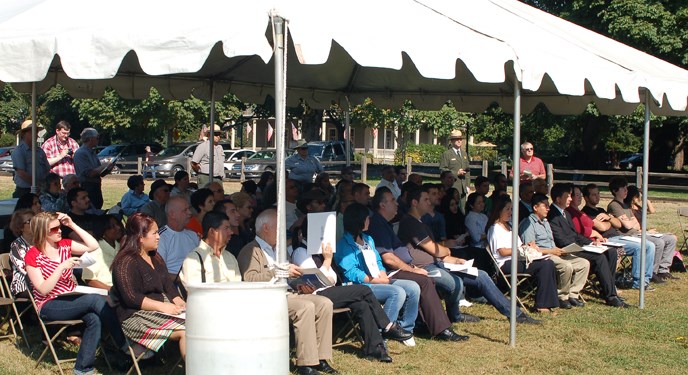 View of candidates for U.S. citizenship under at tent at the park's historic Parade Ground