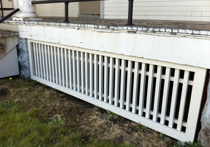Photo of protective latticework under front porch of a barracks building at Vancouver Barracks.