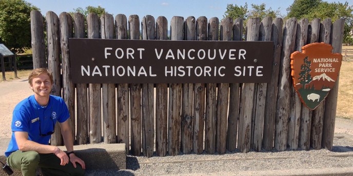 Centennial Volunteer Ambassador Aaron Porter at the park sign.