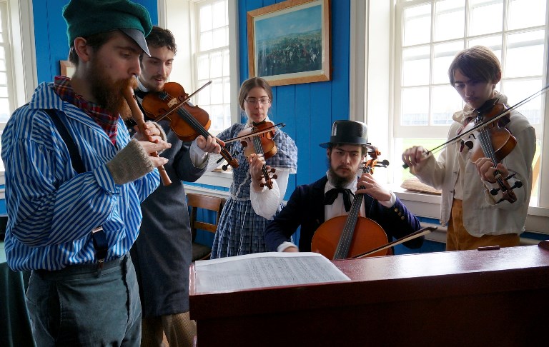 Costumed VIPs play period music in the Counting House - Credit Joe Blanco