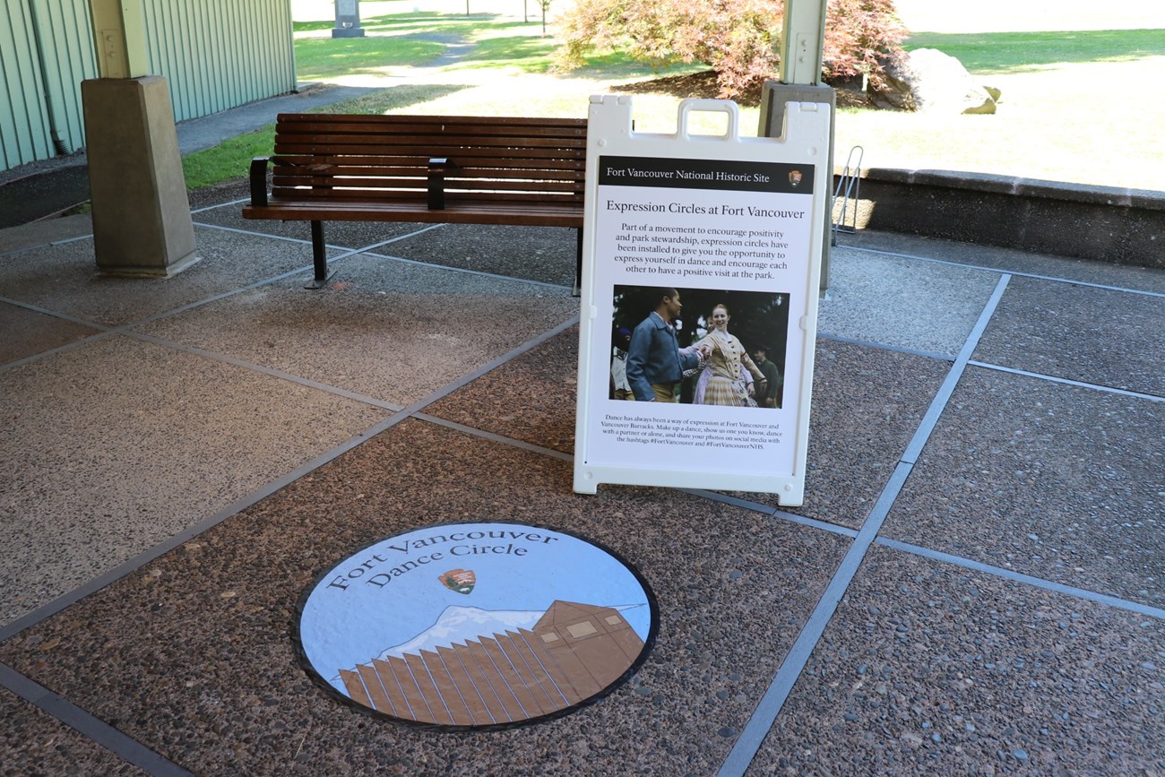 Dance Circle A decal on the ground outside the Fort Vancouver Visitor Center with text reading Dance Circle.