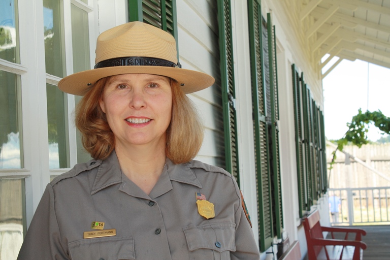 Superintendent Tracy Fortmann on the porch of Fort Vancouver's Chief Factor's House