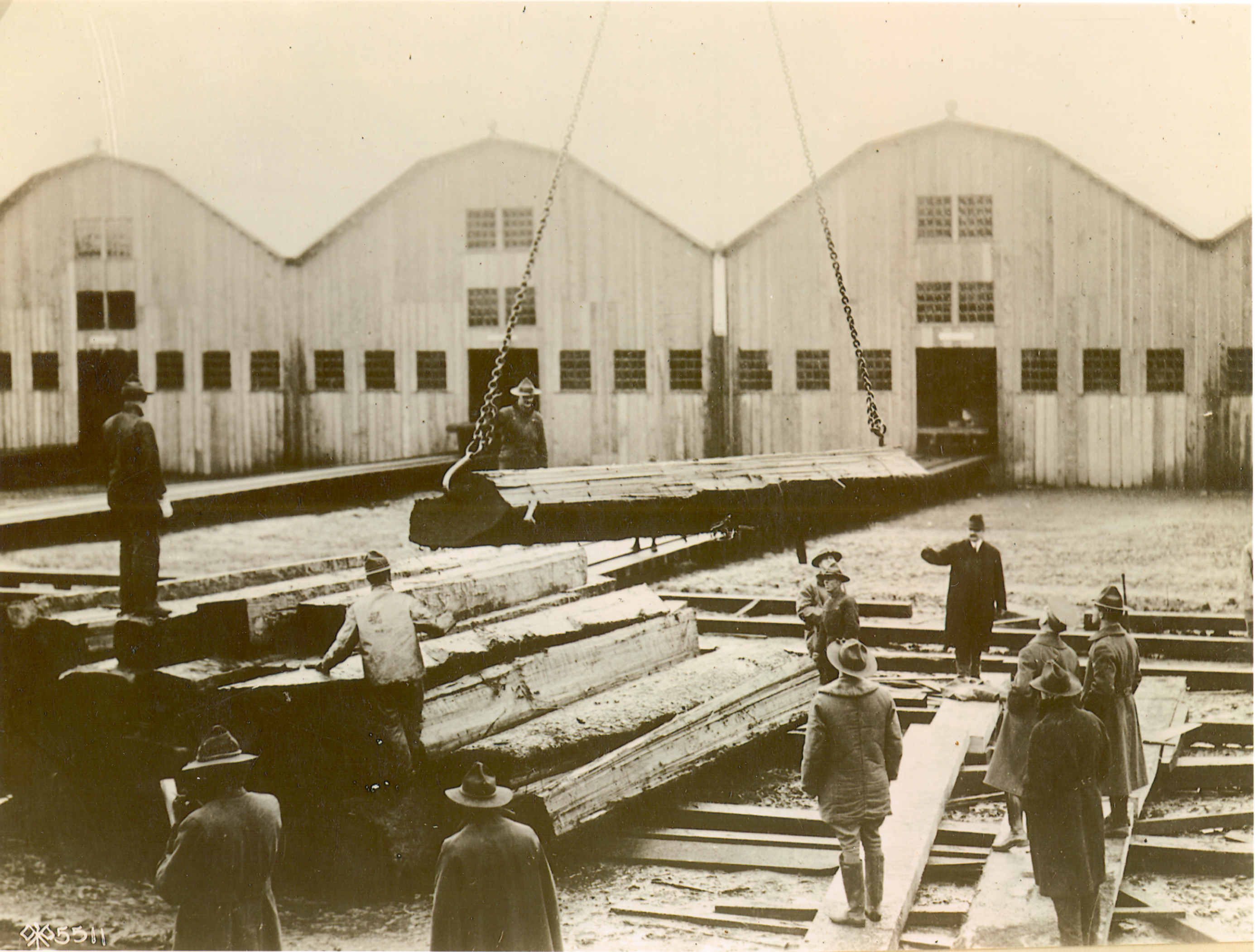 Spruce Production Division soldiers lower beams of lumber at the Spruce Mill at Vancouver Barracks