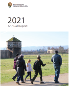 front cover of 2021 Annual Report reads "2021 Annual Report" with a photo of park ranger guiding visitors outdoors.