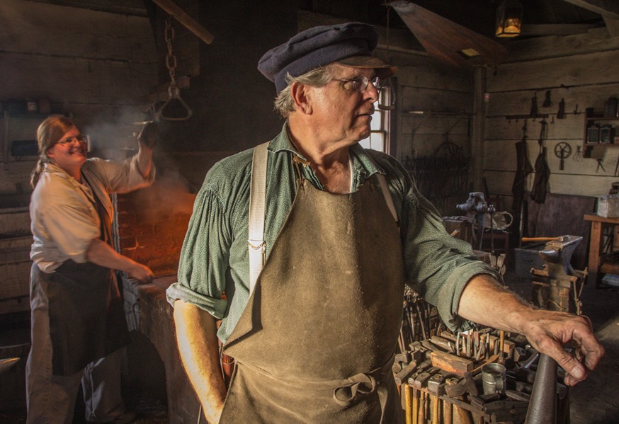 Volunteer blacksmiths work in the Fort Vancouver Blacksmith Shop