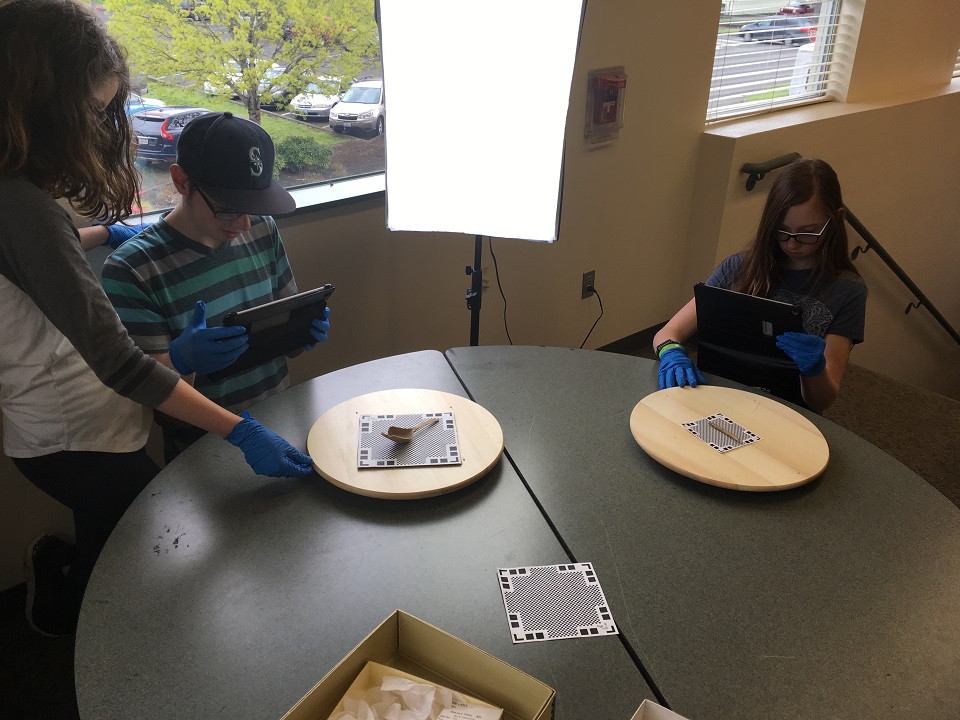 Photo of students working with artifacts.