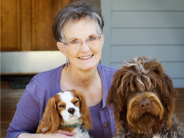 Photograph of Jane Kirkpatrick and two dogs