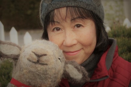 Juneko Martinson Photo of woman holding a felted lamb sculpture.