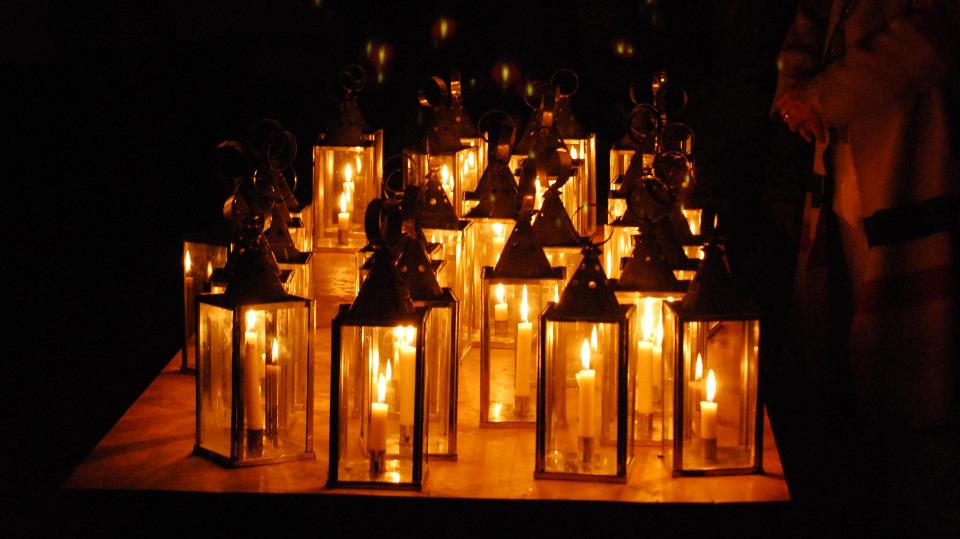 Lit lanterns sit on a table