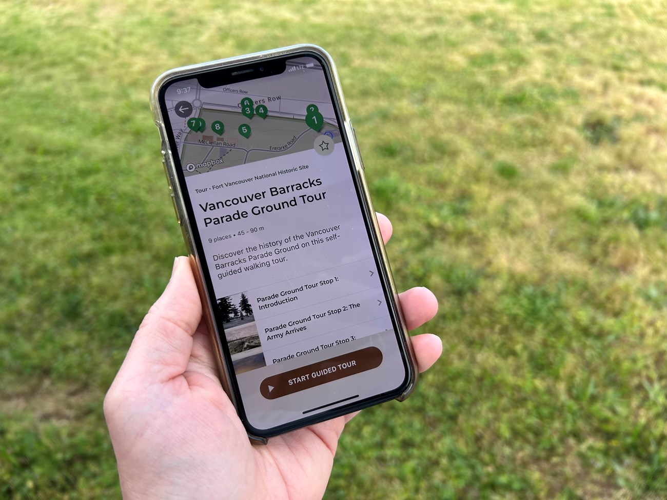 Parade Ground tour A photo of an iPhone in a person's hand with the Parade Ground self-guided tour open in the NPS App.