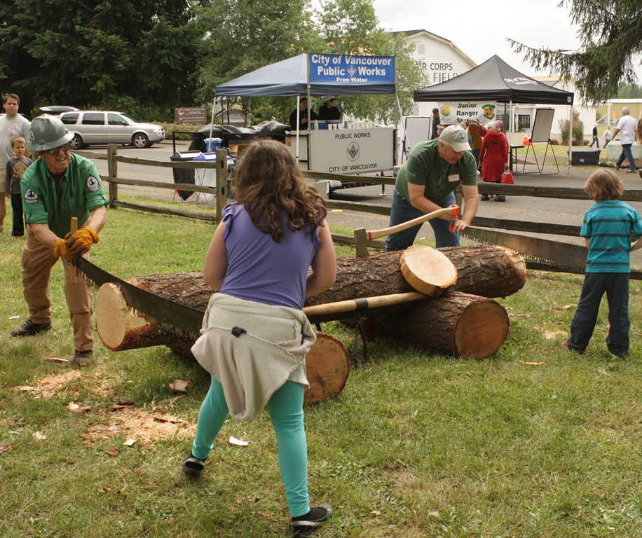 Sawing at GO Day Sawyers and children work together to saw a log at Get Outdoors Day