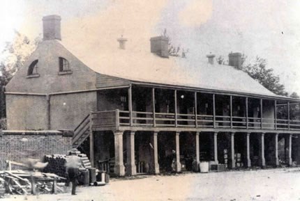 Old fort barracks used to store construction material (Army Signal Corps photo)