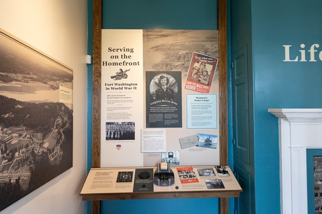 Informational exhibit panels with photos, text, a stenography machine, and a button to activate audio.