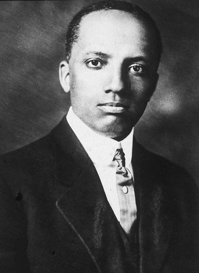 Carter G. Woodson sits for portrait wearing suit