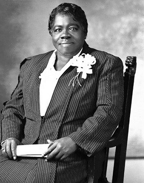 Mary McLeod Bethune sits for portrait with scroll in hand