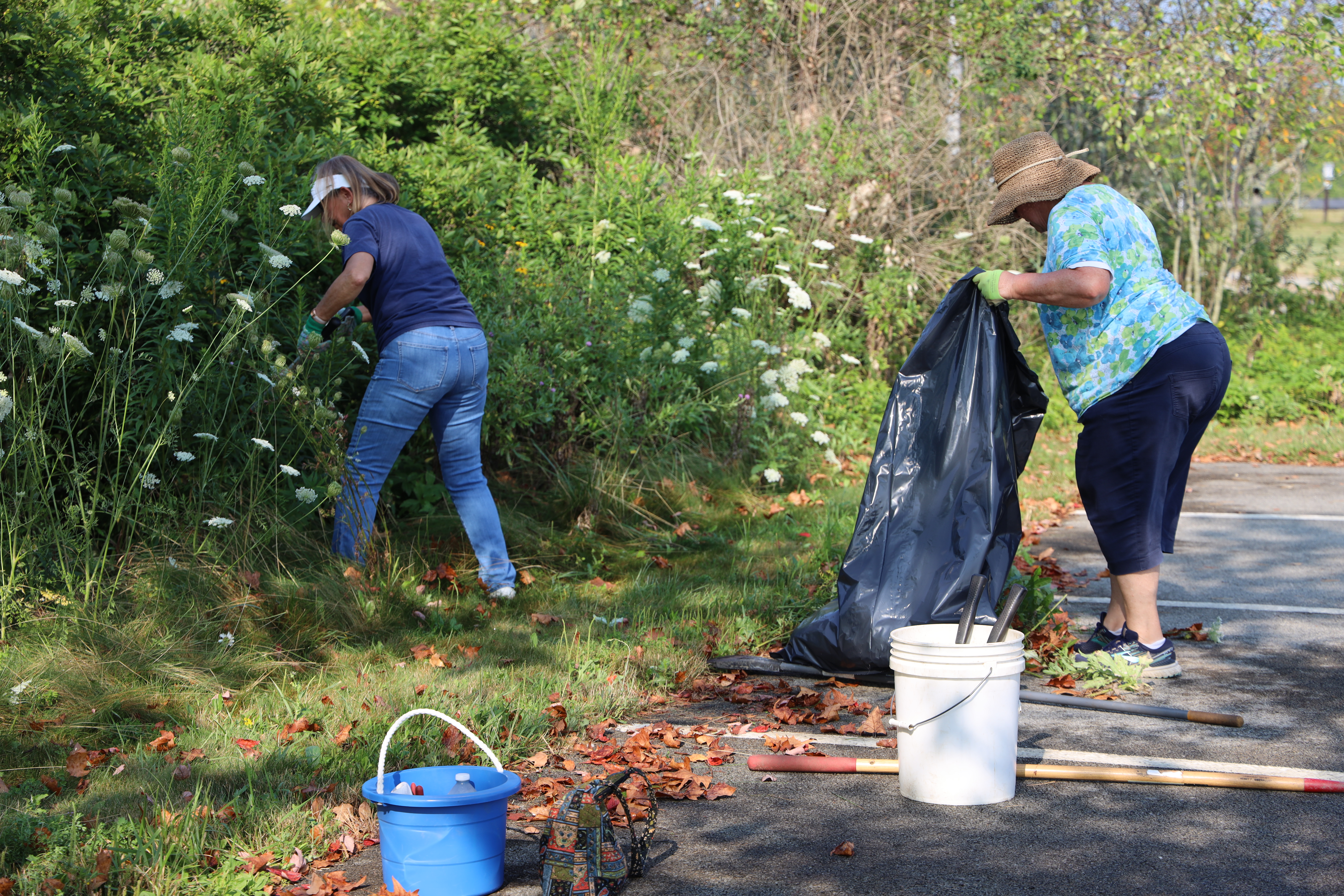 A photo of volunteers cleaning up garbage in the park A photo of volunteers cleaning up garbage in the park