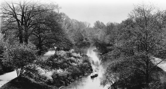 A 1920 photo of a two people canoeing up the Muddy River. See caption further down the page.