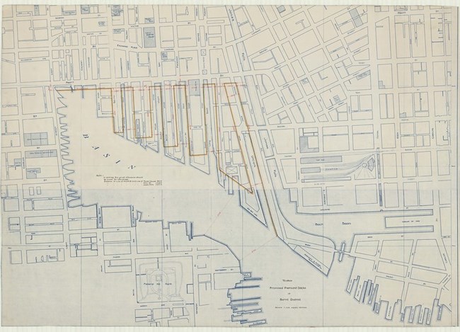 Pencil drawing of city with straight lines for roads in a grid, with a basin cutting into the city