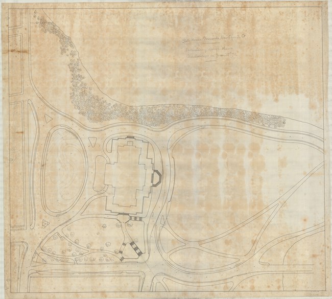 Pencil drawing of many curving roads around symmetrical building. On one side of building, there is a dense planting of trees.