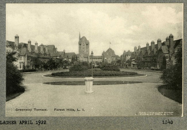 Black and white of circular green space in the center with a road and buildings surrounding.