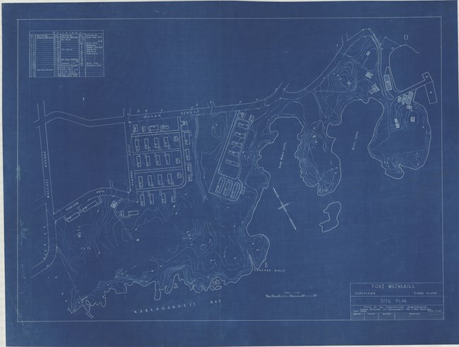 Blue paper with white lines shows buildings lined up on a steep slope, evident from the topographical lines
