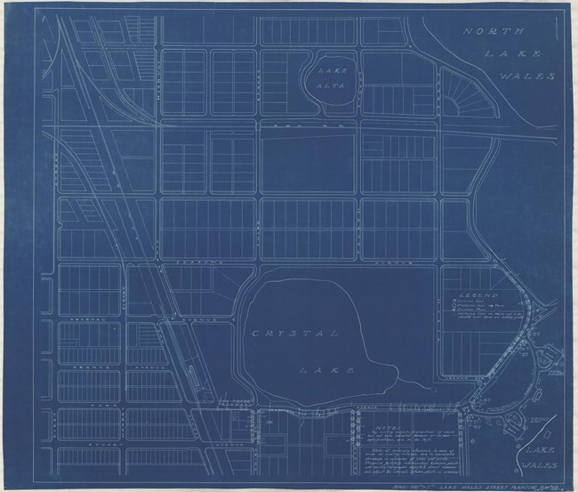 Blueprint of city with many straight lines in a grid with two bodies of water and a larger one on the side