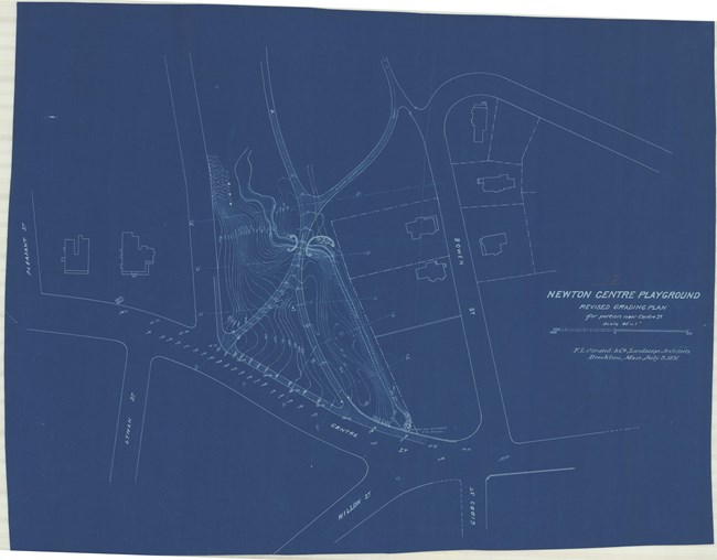Blue paper with white lines shows park nestled between two roads with many close lines showing topography
