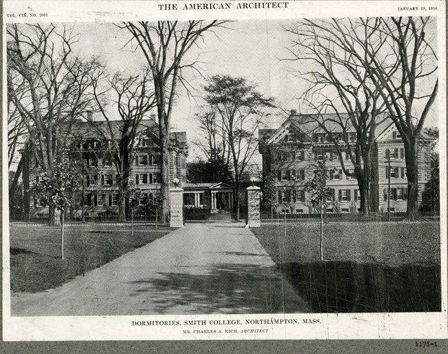 Black and white photograph of dirt road leading to castle like building with grassy areas on both sides of the path, and a few plantings on the edges.