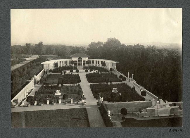 Aerial view of square garden broken into four sections with wall going around. A path turns the large square into four smaller ones.