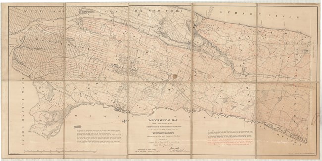 Pencil map of large county with water on one side and other towns on the other, with most of the roads being straight lines, forming a grid.