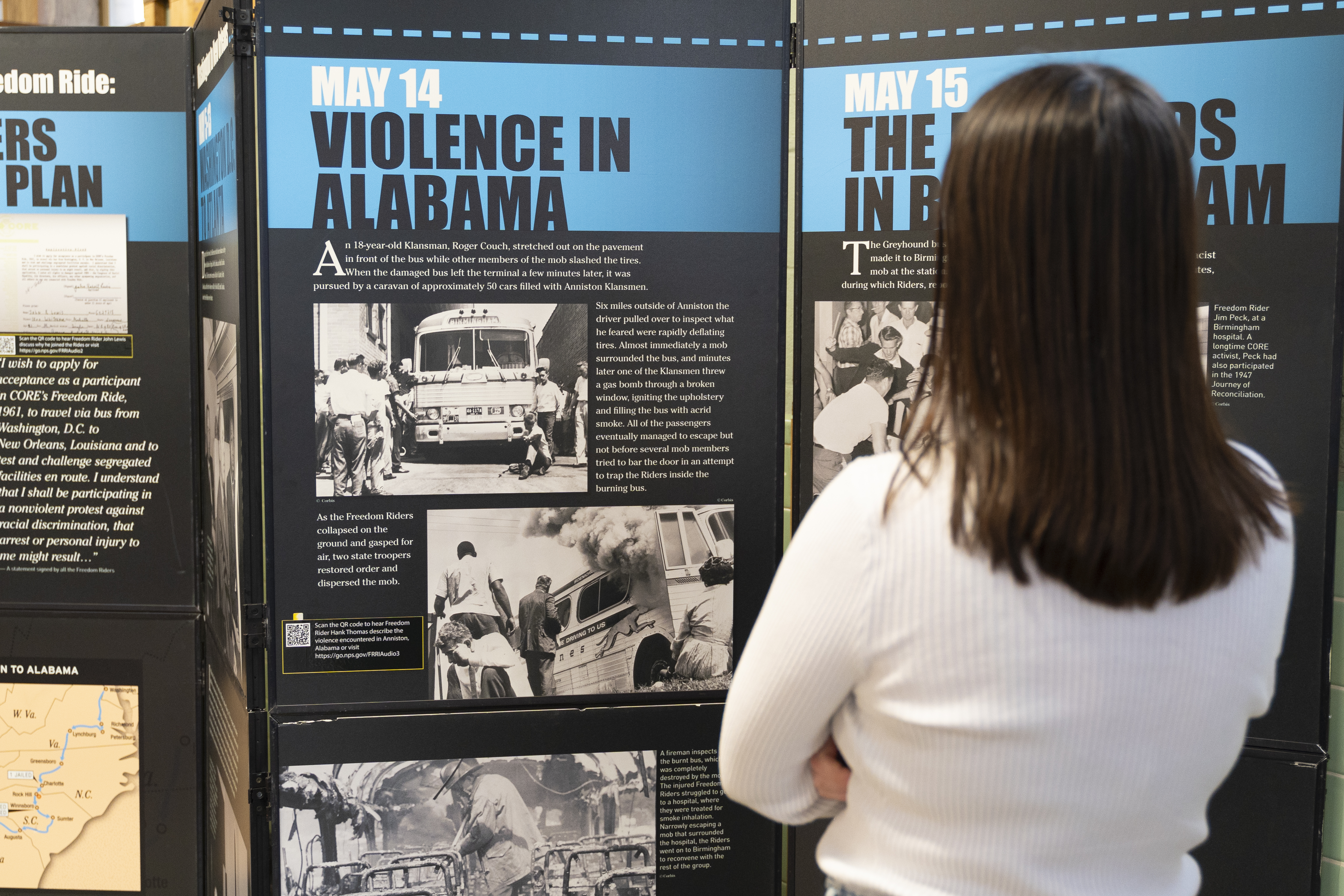 A visitor reads interpretive panels about the Freedom Riders.