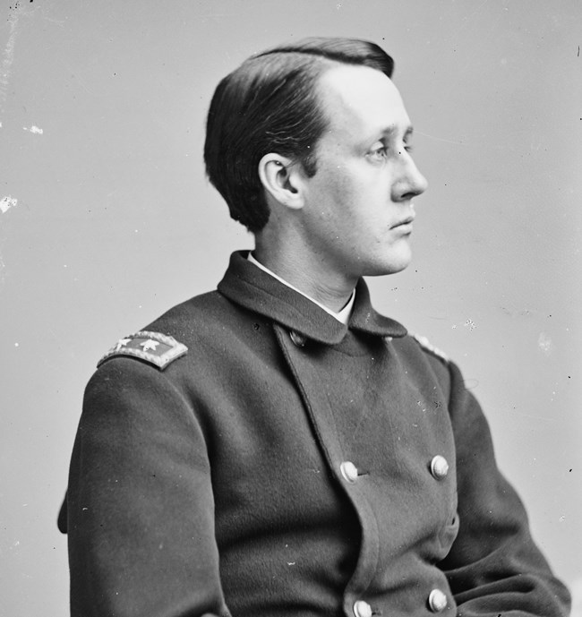 Black and white photograph of uniformed man in his 20's.