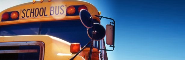 Yellow school bus against blue backdrop Yellow school bus against blue backdrop