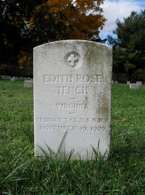 White stone grave with name Edith Rose Tench on grass with cemetery in background