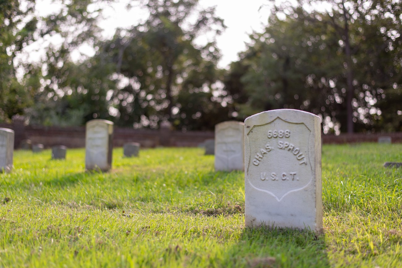 A headstone within a cemetery for Charles Sprow.